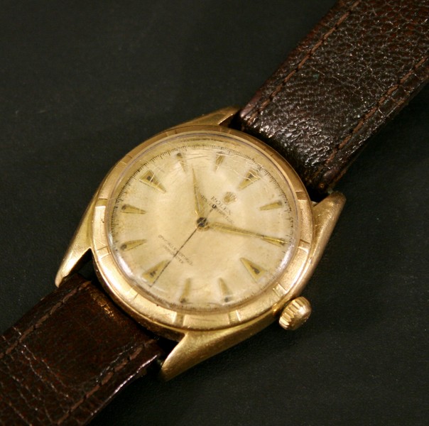 AN 18CT GOLD ROLEX OYSTER PERPETUAL WRISTWATCH of circular form with baton hour markers framing the