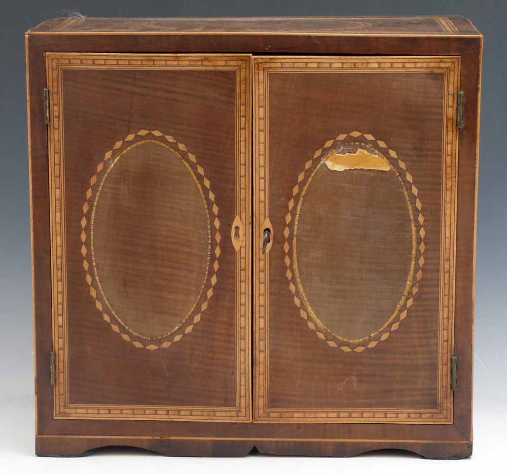 Fiddle back mahogany table top cabinet circa 1820, of two doors enclosing two short and three long