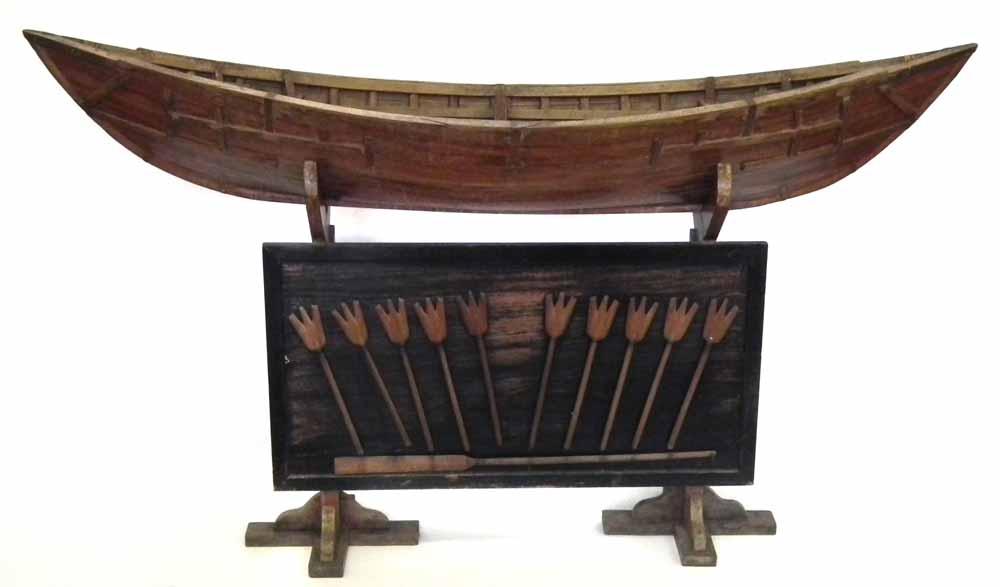 Camphor wood model of Polynesian boat   mounted on stand set with a display of oars, late 19th /