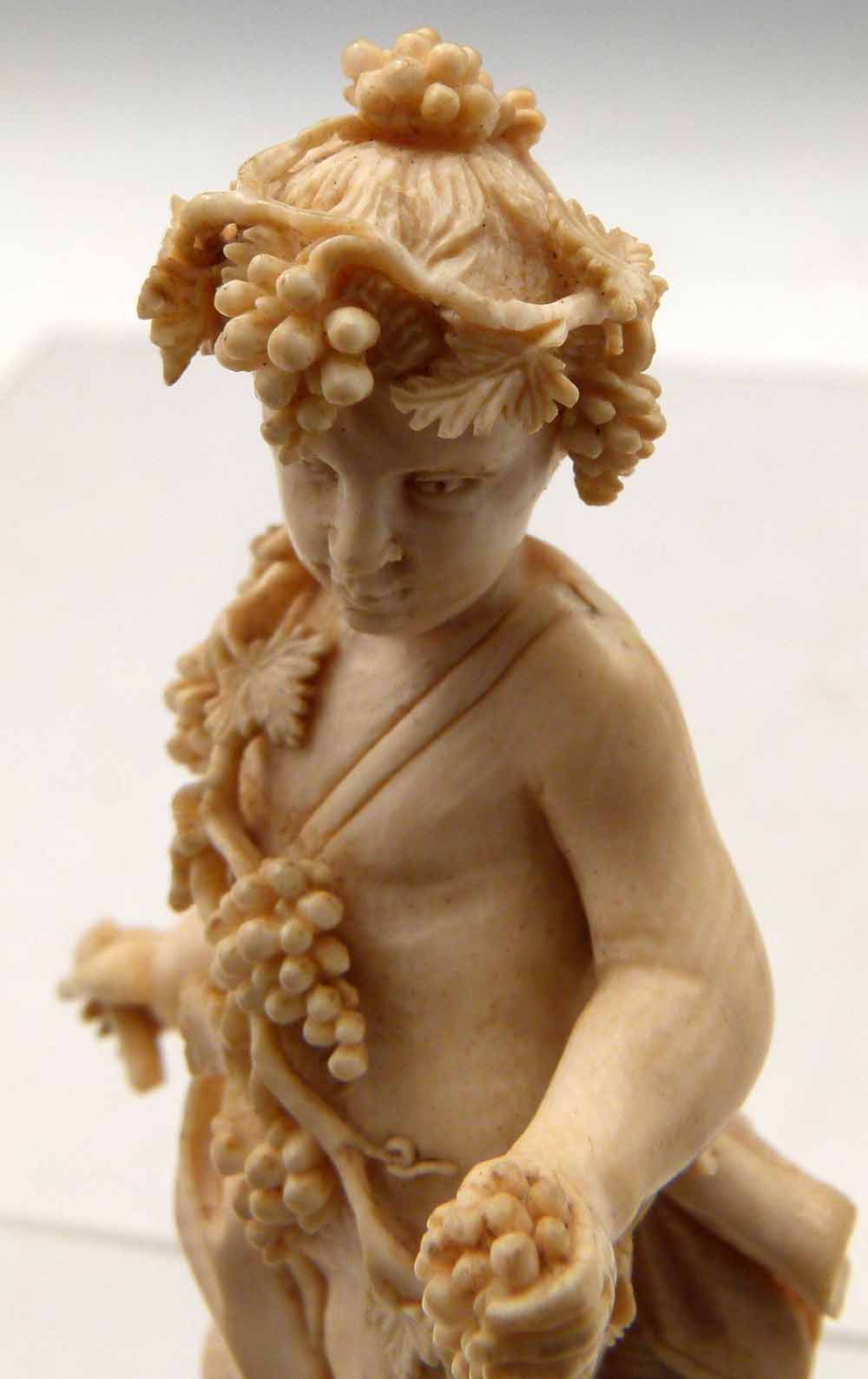 Carved ivory Bacchanalian standing figure of a boy draped with vines and grapes, leaning against a - Image 5 of 5