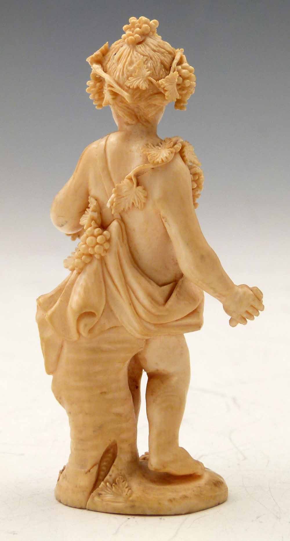 Carved ivory Bacchanalian standing figure of a boy draped with vines and grapes, leaning against a - Image 2 of 5