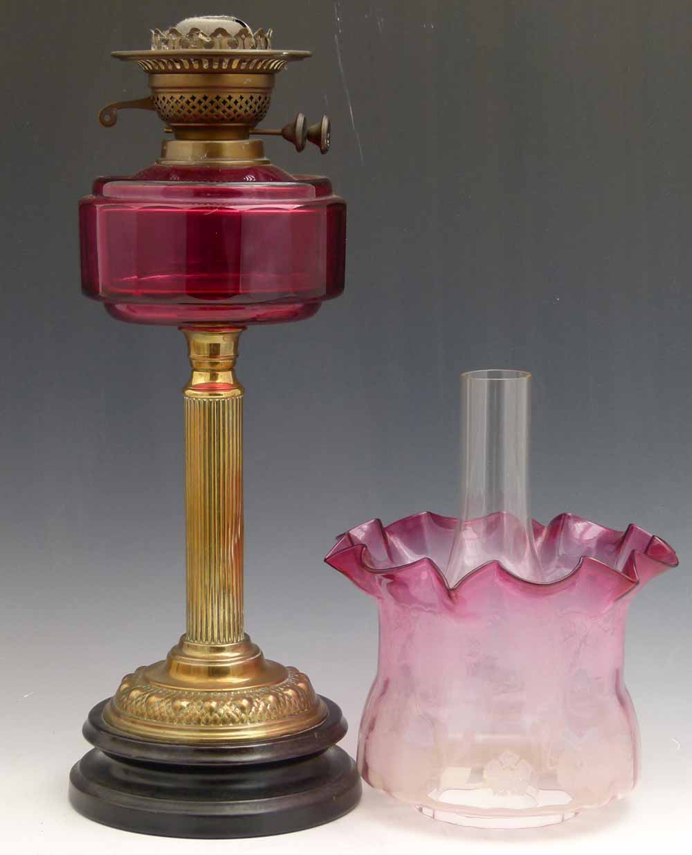 Victorian table oil lamp, the ruby glass reservoir on a reeded brass column, duplex burner, ruby