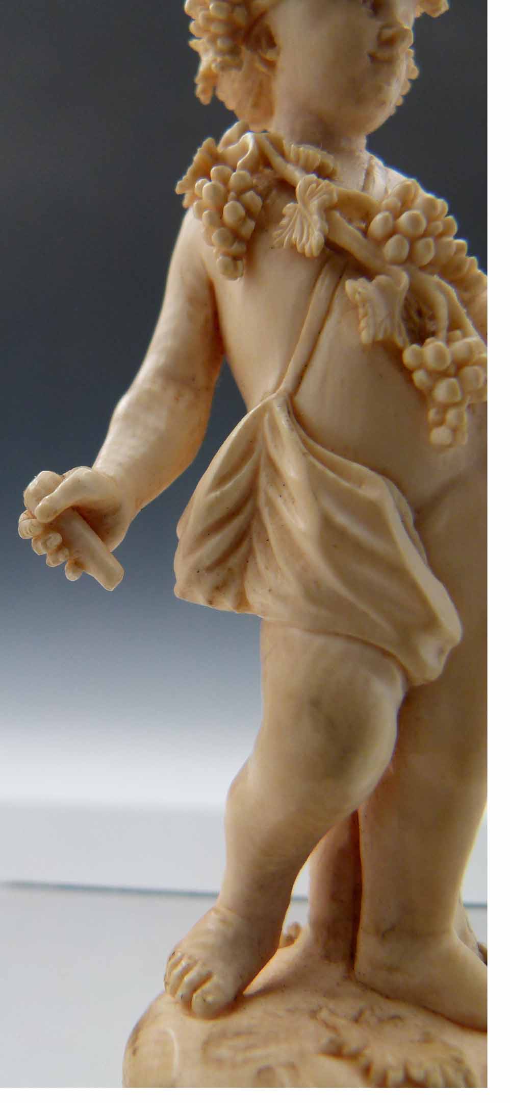 Carved ivory Bacchanalian standing figure of a boy draped with vines and grapes, leaning against a - Image 3 of 5