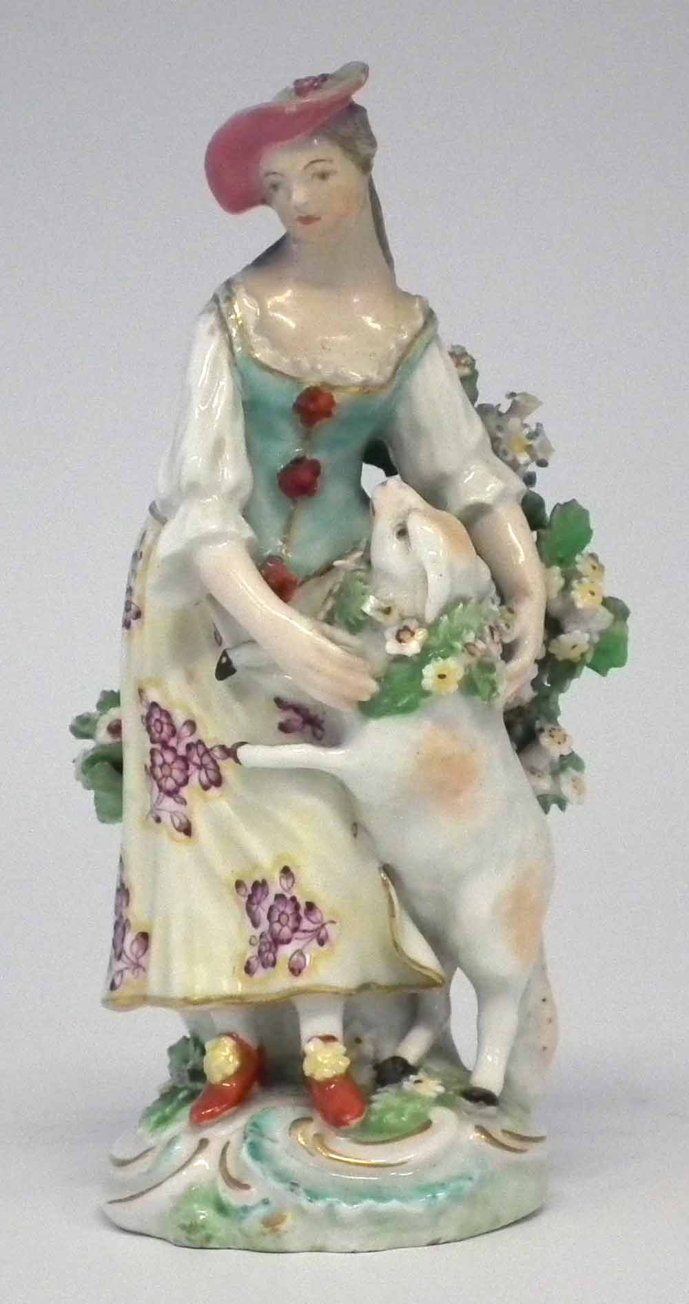 Derby figure circa 1770   modelled as a lady with a sheep, patch marks to base, 14cm high