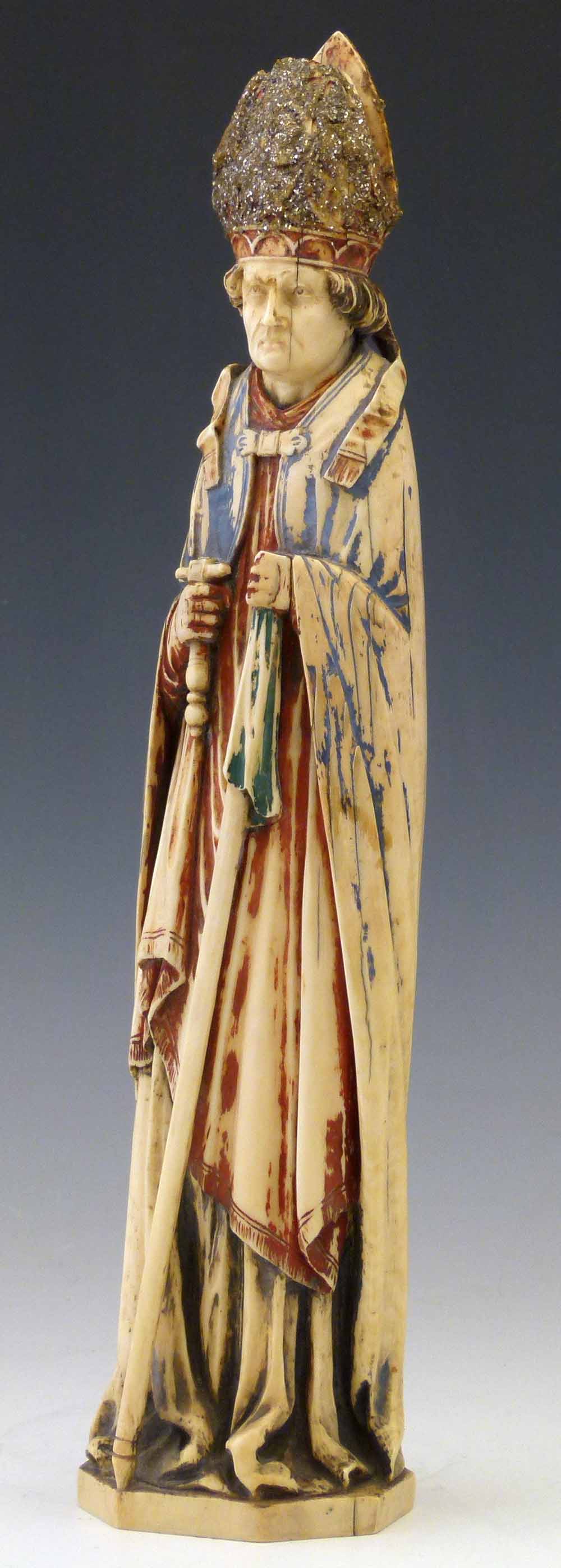 Dieppe ivory standing figure of a bishop, 19th century, holding a crozier and sword, in red and blue