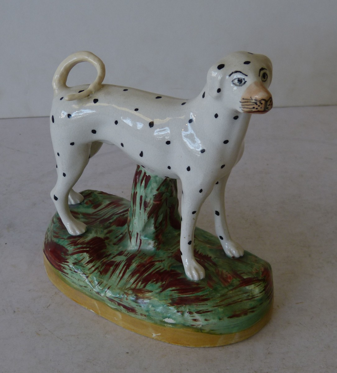 A 19th Century Staffordshire Figure of a Dalmatian on oblong base, 16.5cm high (tail restored)