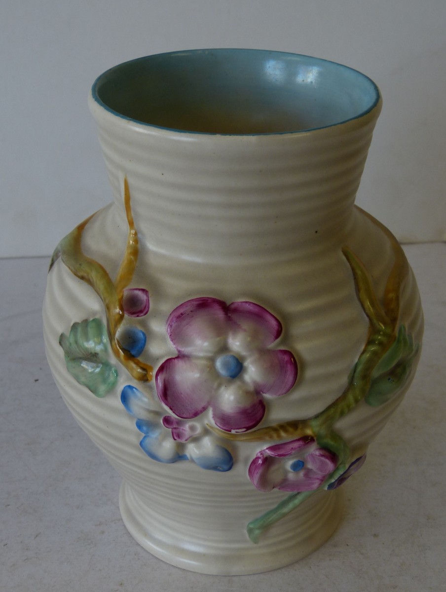 A Clarice Cliff Round Bulbous Thin Necked Vase, having rimmed decoration with raised coloured,