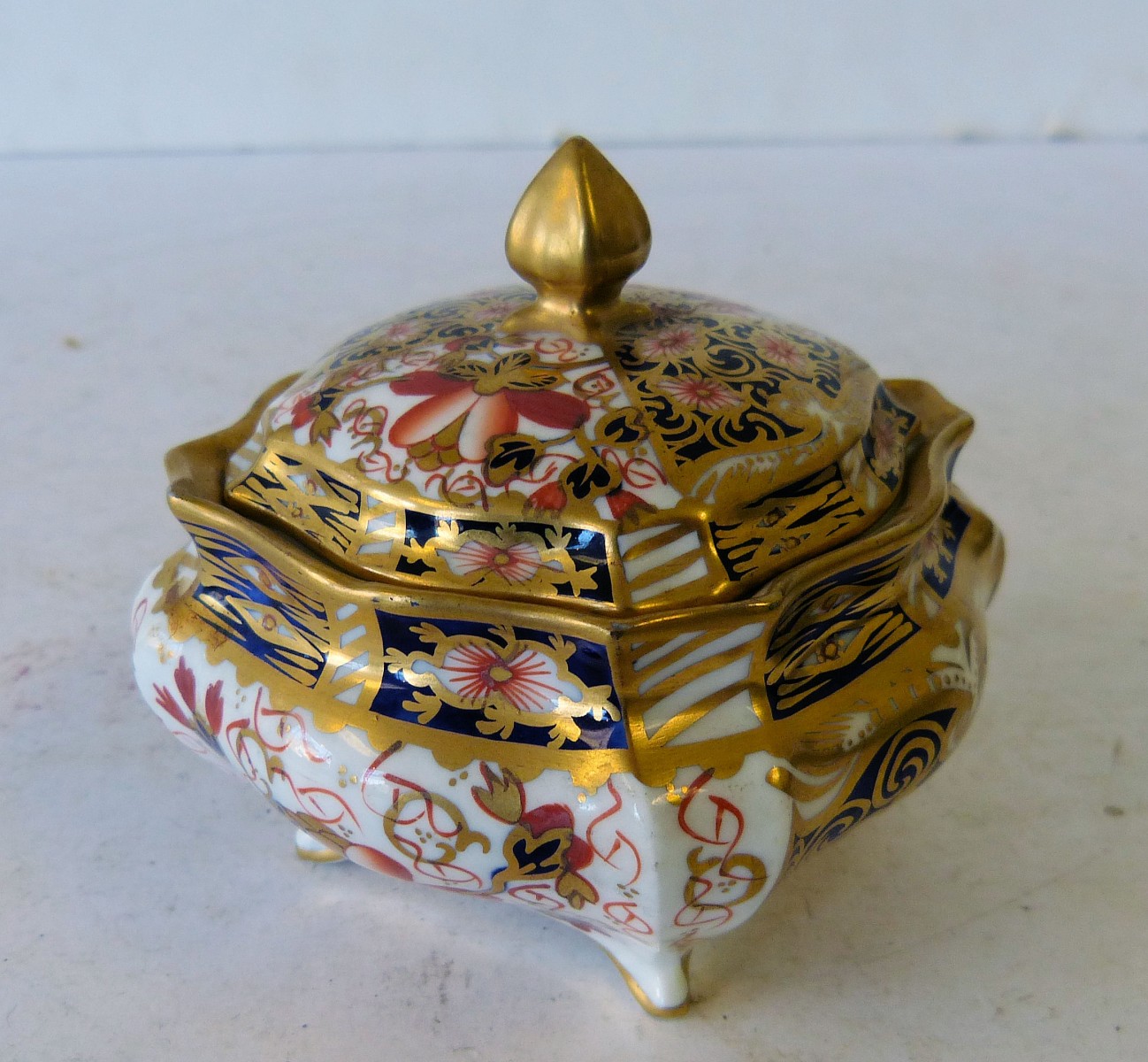 A Royal Crown Derby Imari Pattern Square Scalloped Shaped Lidded Pot, having all over gilt
