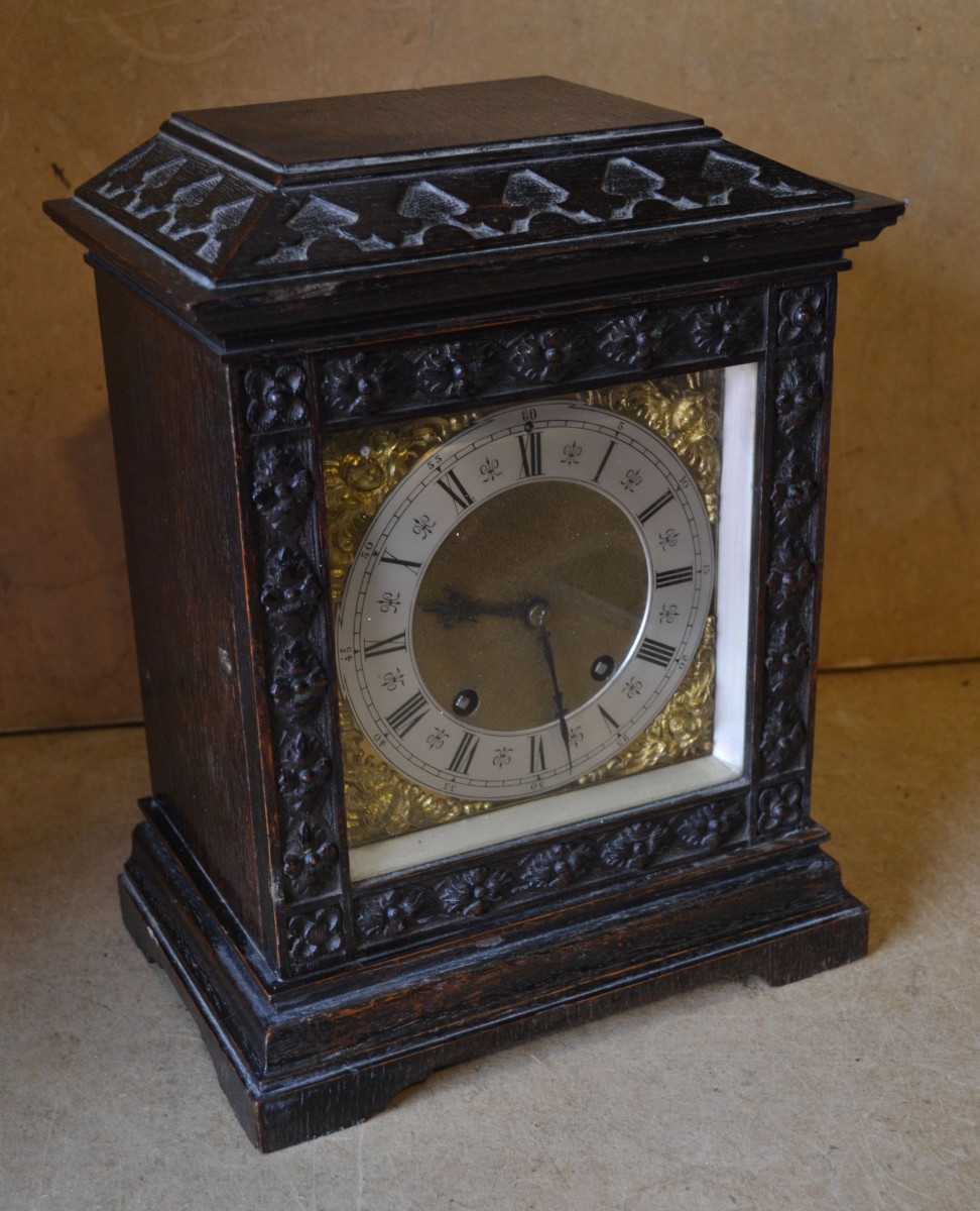 A Lenzkirch Oak 8 Day Striking Mantel Clock, having square brass dial, with Roman and Arabic