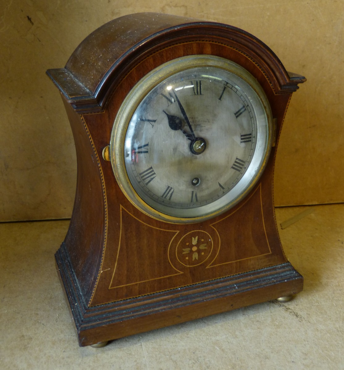 A Mappin Edwardian Mahogany Mantle Clock having arched top, with inlaid floral stringing and boxing