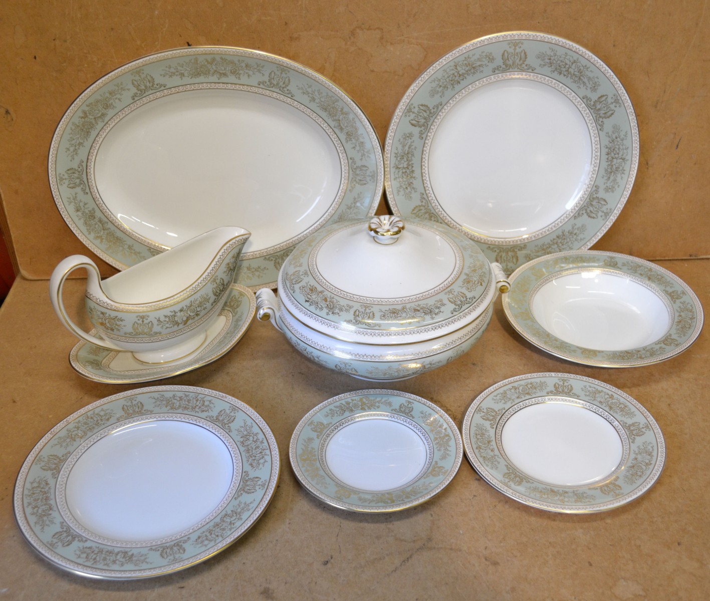 A Wedgwood ""Gold Columbia"" Pattern Dinner service, on white and green ground, with gilt
