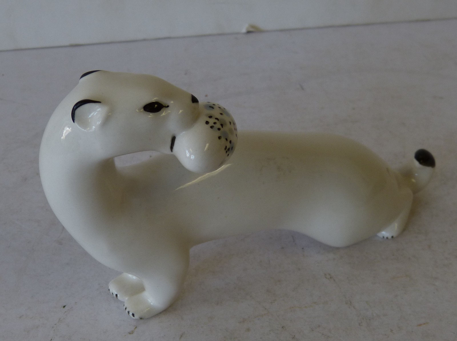 An USSR China Figure of a Stoat on white ground, 18.5cm long