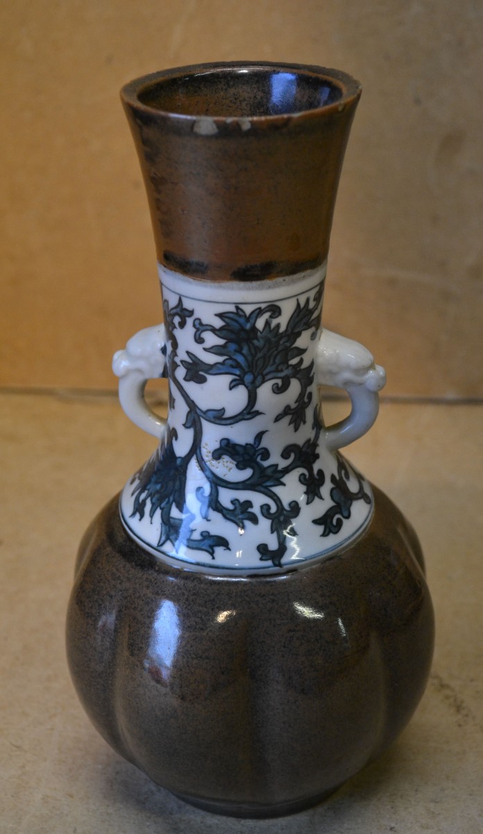 An Oriental Bulbous Thin Necked Trumpet Shape 2-handled Vase on brown, white and blue ground with