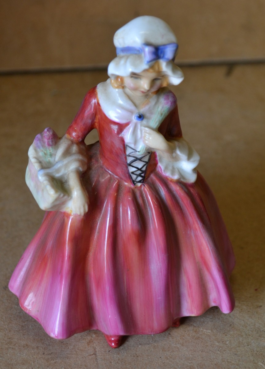 A Small Royal Doulton Figurine ""Lavinia"" in form of the lady in red dress holding a basket, 13.