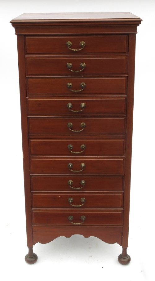 An Edwardian mahogany music cabinet, fitted ten drop flap drawers, raised on four turned legs, width