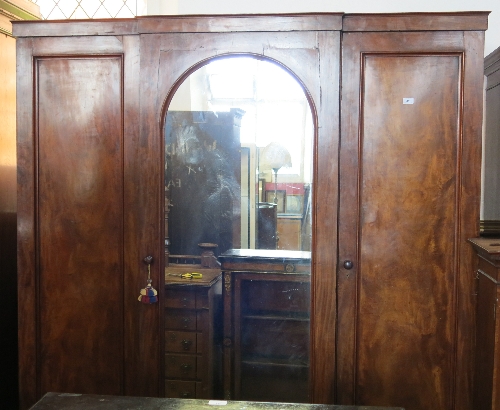 A Victorian mahogany compactum linen press, having upper section of hanging space with drawers