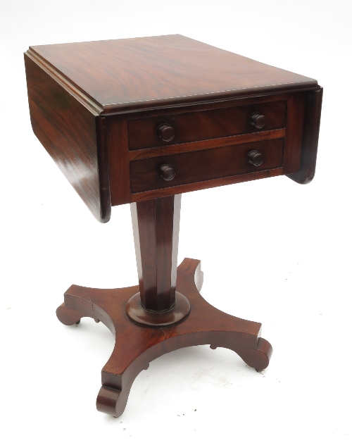 A 19th century mahogany work table, fitted two drawers and dummy drawers below the two flaps, raised