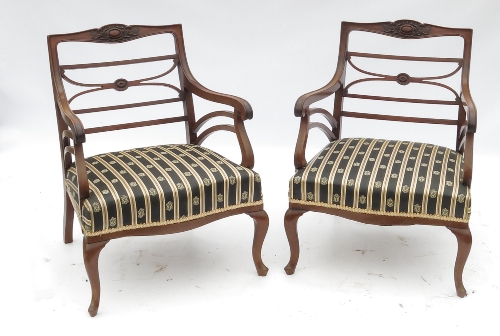 A pair of late 19th century low ladder back armchairs, with elongated central cross splat, raised on