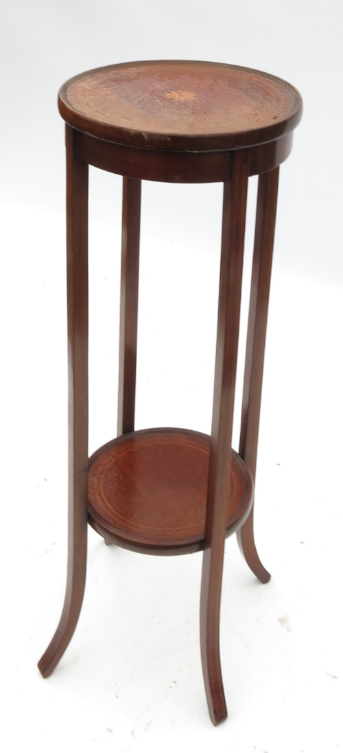 An Edwardian mahogany circular jardinière stand, with central satinwood inlay, and plant shelf
