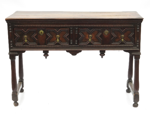 An Antique oak side table, or short dresser, having two moulded front drawers with further bobbin