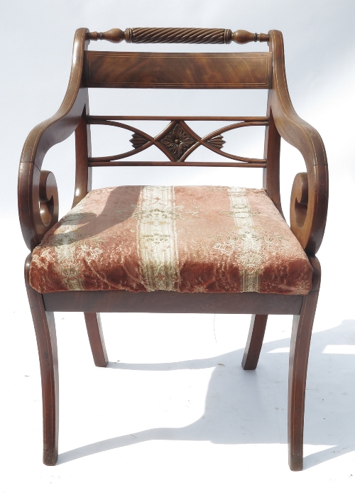 A Regency mahogany armchair, with scroll arms and bar back below a rope twist, raised on sabre legs