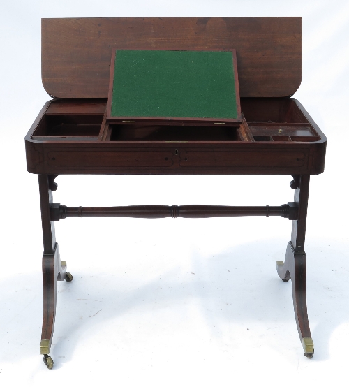 A 19th century mahogany writing table, the top with folding action to reveal an adjustable writing