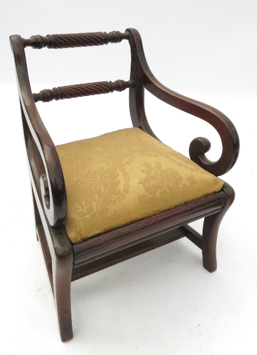 A 19th century child's armchair, with double rope twist back and scroll arms, raised on outswept