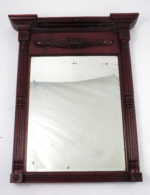 A 19th century mahogany framed wall mirror, the frame of architectural design with columns and