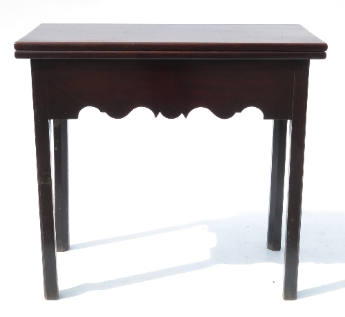 A Georgian mahogany rectangular shaped fold over tea table, fitted with end drawer within the shaped