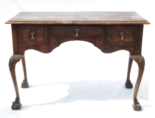 A walnut lowboy, in the early 18th century style, with quarter veneered and cross banded top, fitted