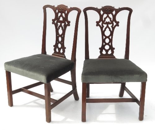 A set of four Chippendale style mahogany dining chairs, with pierced vase splat and fleur de lys