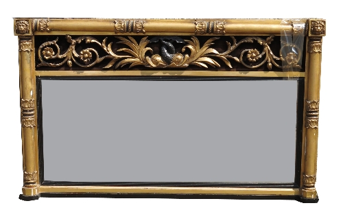 A Regency design mirror, with column supports, having a scrolling cresting rail of dolphins, 31ins x