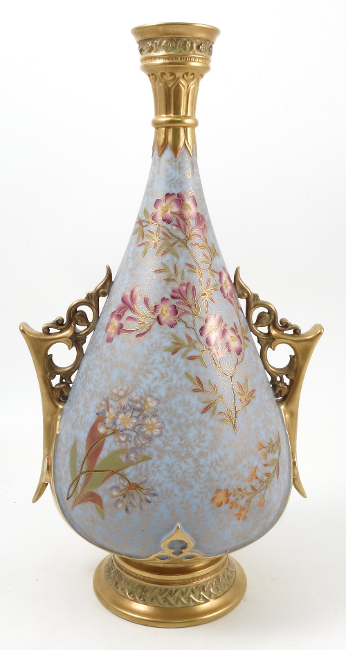 A Royal Worcester vase, decorated with flowers and leaves to a pale blue ground, with gilt