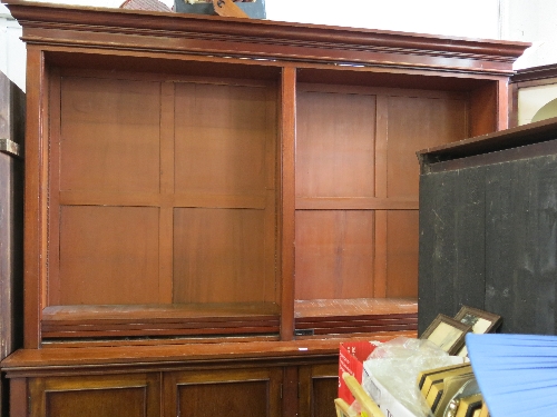 A 19th century mahogany bookcase, having an upper open section, with adjustable shelves, fitted four