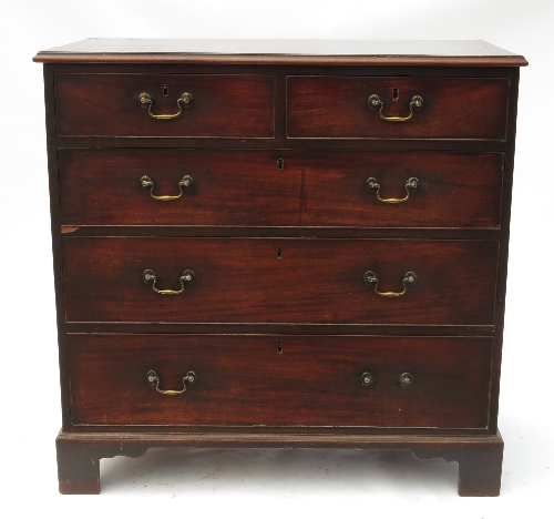 A Georgian design mahogany chest, fitted two short drawers over three long drawers, raised on