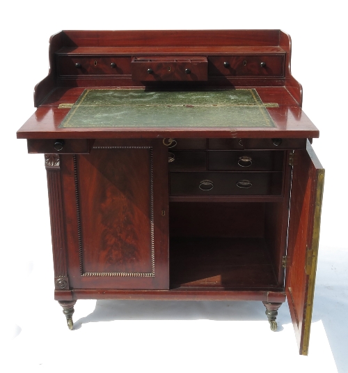 A 19th century mahogany secretaire cupboard, having fold out writing flap with three drawers over,