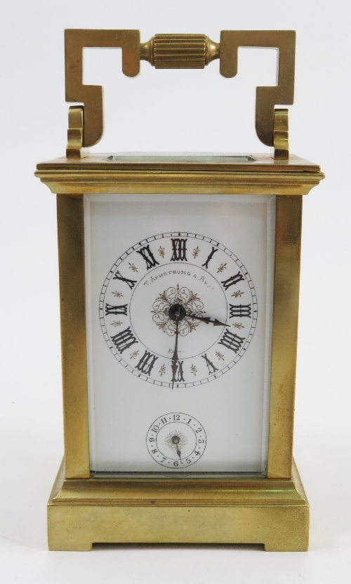 A gilt metal striking carriage clock, the white enamel dial with Roman numerals, subsidiary dial and