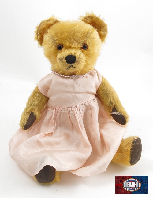 A 1940's Chad Valley musical teddy bear, in gold plush, with jointed limbs, height 15ins