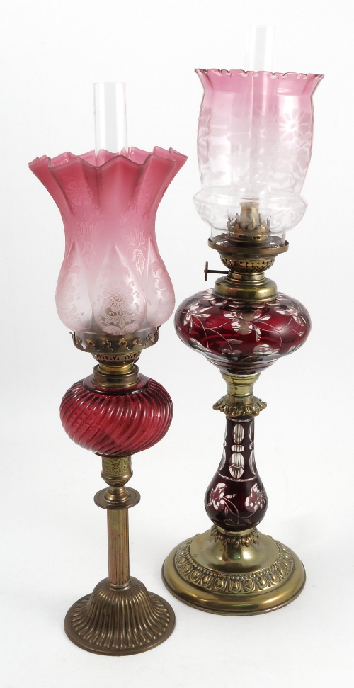 A brass and glass oil lamp, with cut ruby glass to the reserve and column, with part cranberry