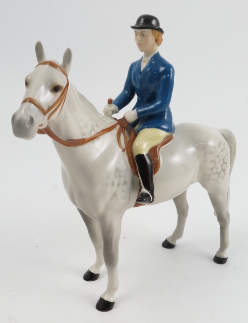 A Beswick model, of a huntswoman, in blue coat on a standing grey horse, model number 1730, height