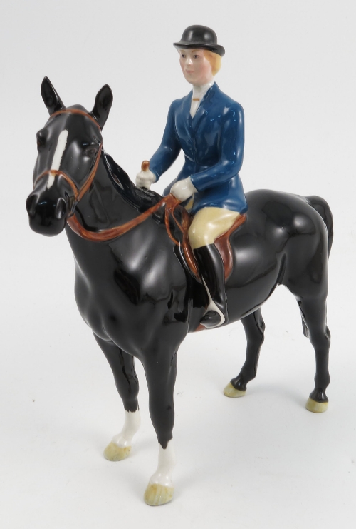 A Beswick model, of a huntswoman, in blue coat on a standing black horse, model number 1730,