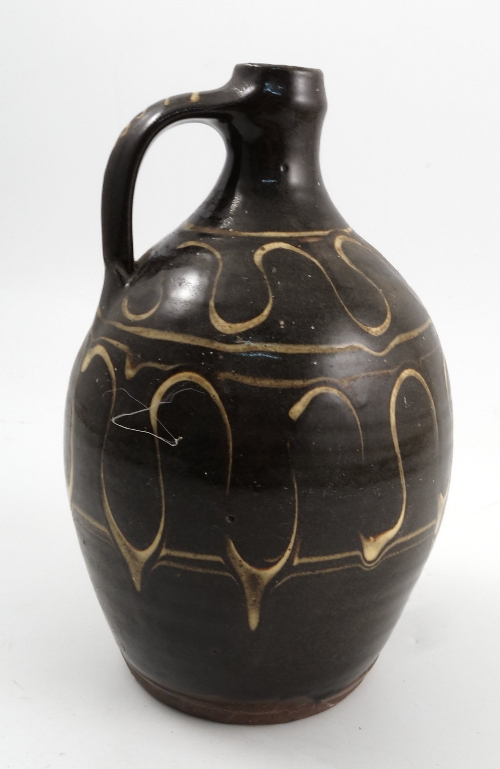 A Winchcombe Pottery slipware flagon, the brown glaze body decorated with two brands of a yellow