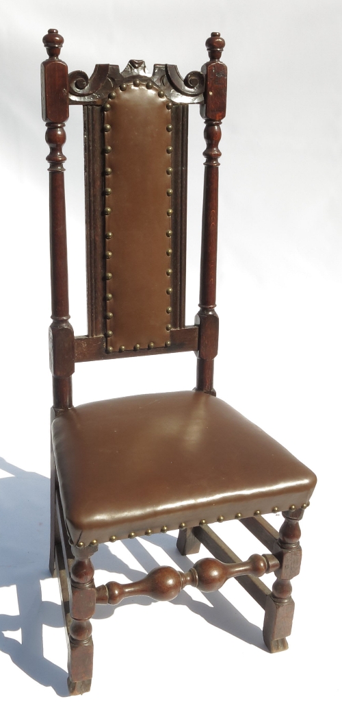 An early 18th century oak chair, with panelled back, raised on turned legs