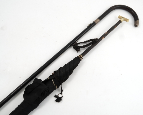A ladies black umbrella, with black leather covered handle and ivorine T end, together with a