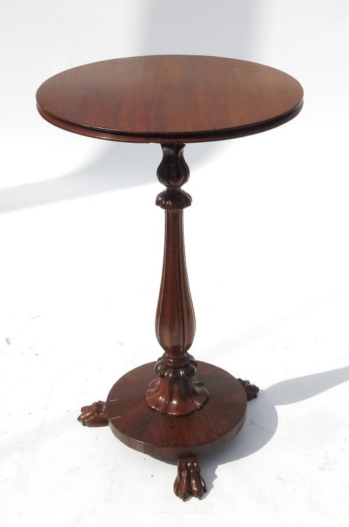 A circular occasional table, raised on a turned column and three hairy paw feet, width 17.5ins