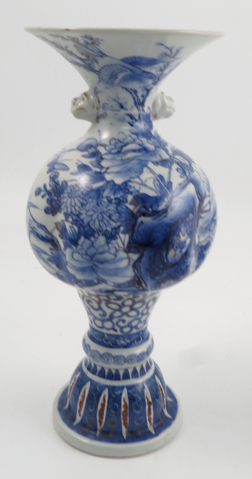 An early 20th century Japanese vase, of bulbous form, decorated in underglaze blue with a Japanese