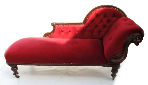 A 19th century mahogany chaise longue, with showwood frame and lions mask scroll, raised on turned