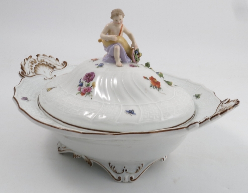 A Meissen tureen and cover, surmounted by a young girl with cornucopia of fruit and flowers