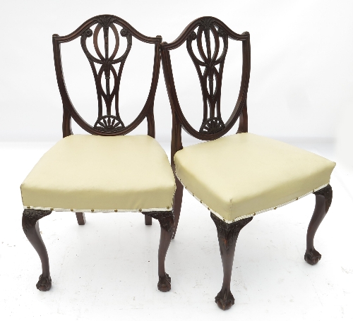 A set of four Hepplewhite style mahogany dining chairs, raised on slender cabriole legs