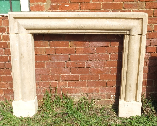 A stone fireplace, with half round moulded border, width 61ins